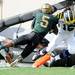 Michigan junior quarterback Denard Robinson makes his way past Michigan State junior cornerback Johnny Adams and into the end zone for a touchdown during the first quarter at Spartan Stadium on Saturday. Melanie Maxwell I AnnArbor.com